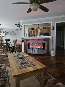 Custom-built cherry fireplace surround. Ambient lighting built-in with a raised hearth, ceramic tile and moveable.